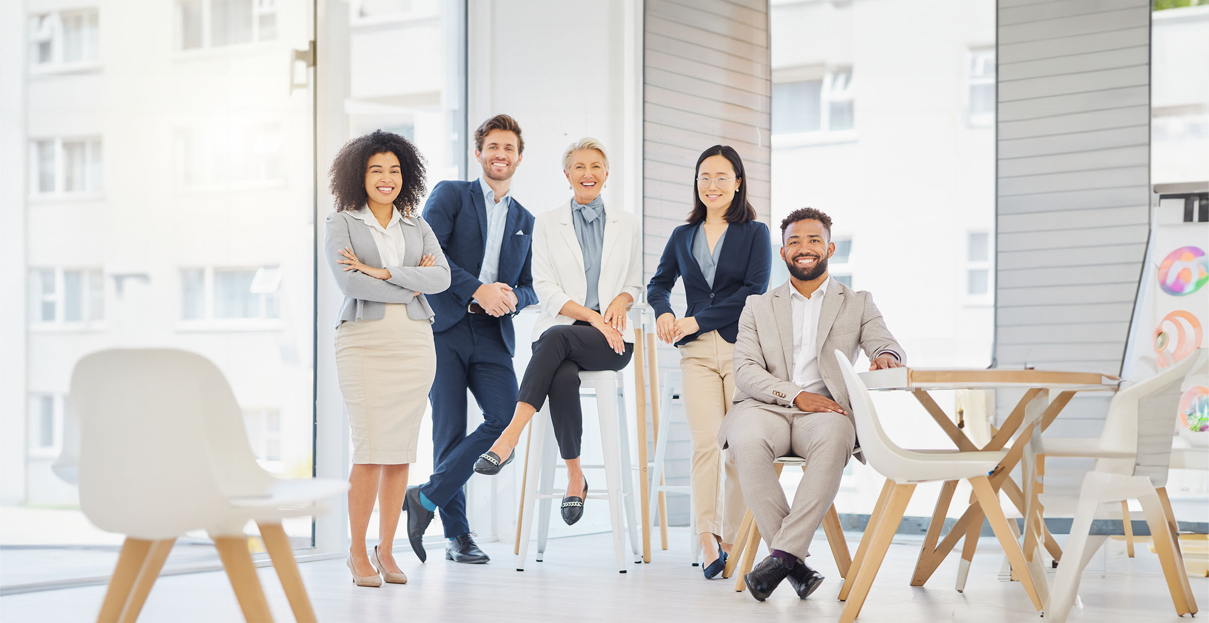 Portrait of a group of confident diverse businesspeople posing together in an office. Happy smiling.